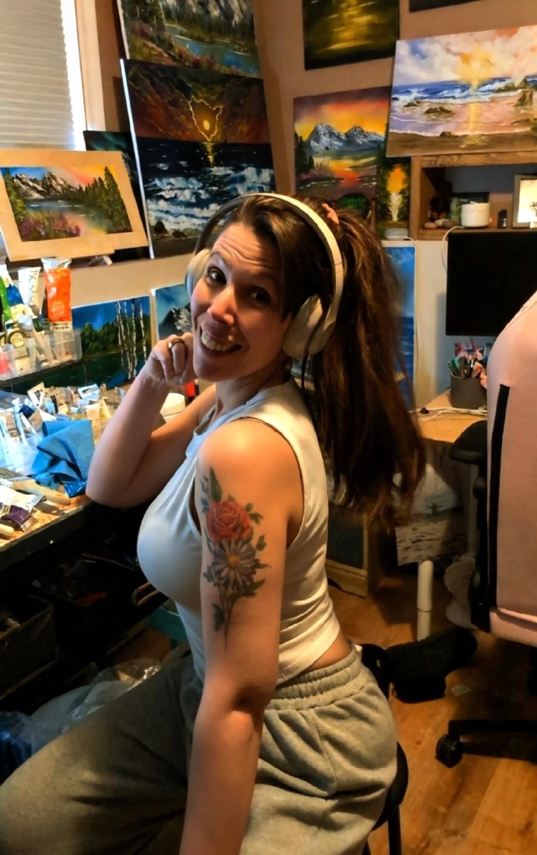 Michelle MacKinnon in her studio, surrounded by her finished oil paintings